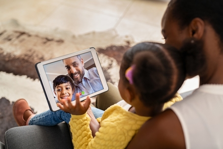 mother and daughter on a video call with father and son