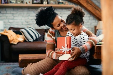 mother and daughter opening presents