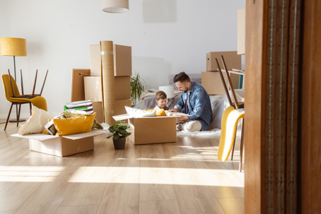 father and son packing up living room