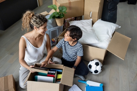 mother and son packing boxes