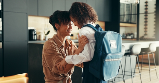 mother helping daughter get ready for school